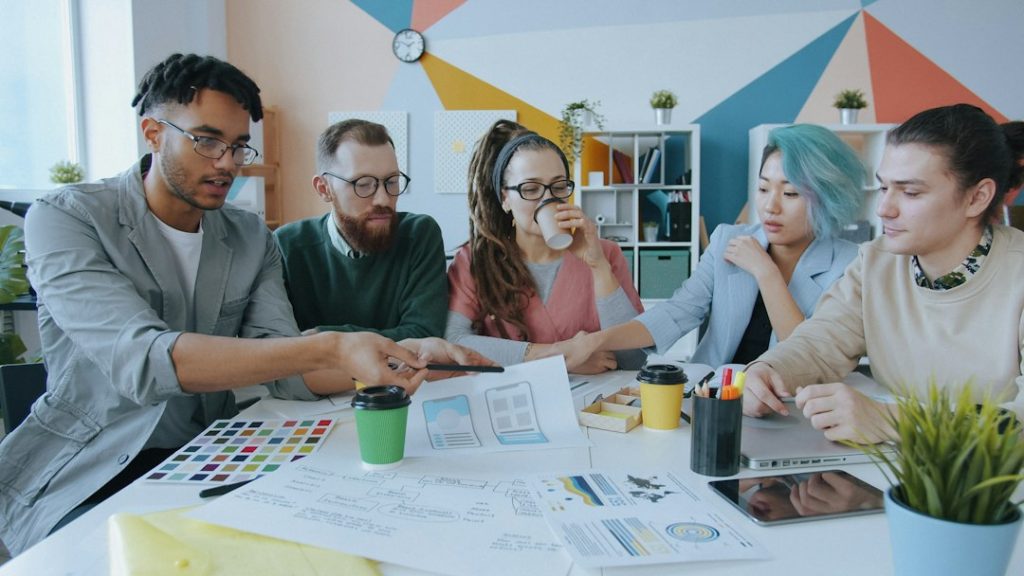 Creative web design team discussing interface and colors.